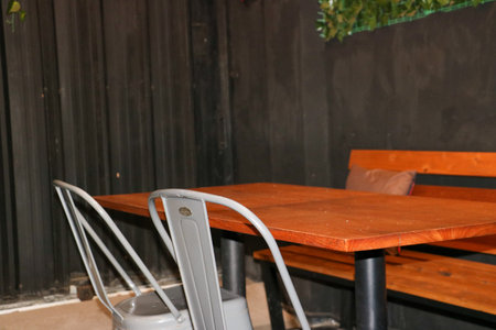 A stylish black iron cafe chair features a modern industrial design for outdoor dining