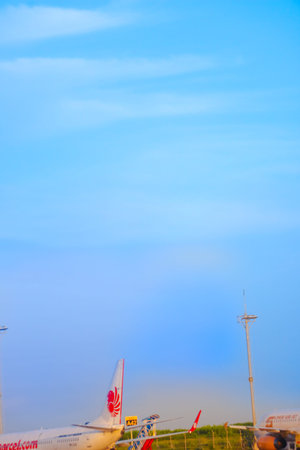 Commercial Boeing 737 900ER aircraft with Lion Parcel livery parked on the sunny apron of Bali airport, Indonesia 19 May 2025のeditorial素材