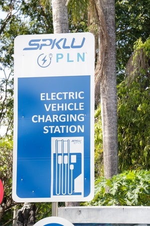 Blue and white SPKLU PLN signage for electric vehicle charging station Denpasar Indonesia 17 April 2025のeditorial素材