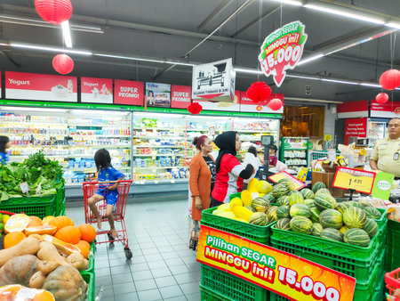Shoppers browse fresh produce and cooking oil at a busy Superindo supermarket during the Ramadan...