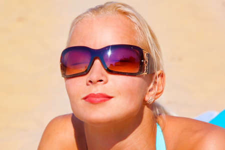 beautiful girl in bikini laying om the beachの写真素材