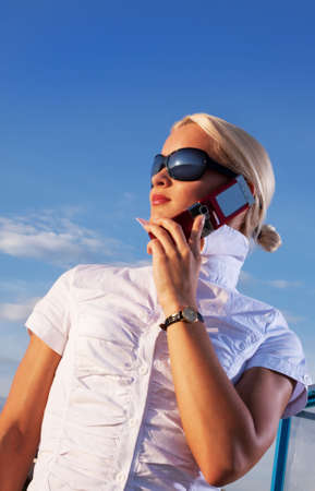 Attractive young woman calling by cellular phoneの写真素材