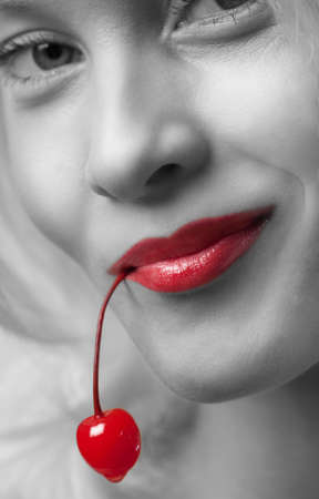 Young beautiful girl holding a cherryの写真素材