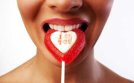 Picture of bitten candy, shiny lips and white teethの写真素材