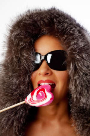 Portrait of young sexy woman eating Christmas candyの写真素材