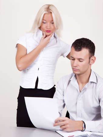 Portrait of supervisor and his secretary analysing reportの写真素材