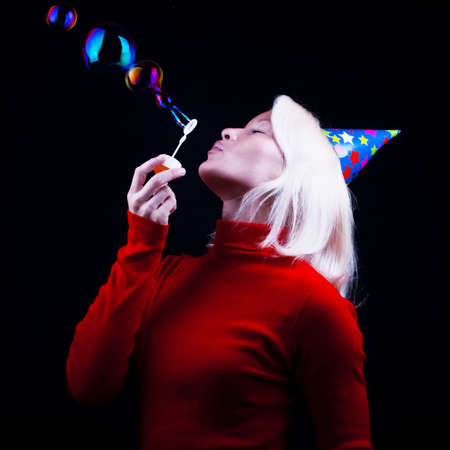 Portrait of attractive woman blowing bubblesの写真素材