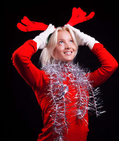Portrait of a cute pensive woman with horns on her head. Christmas timeの写真素材