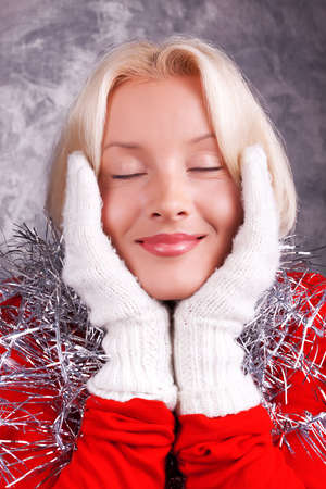 Young happy blonde closing her eyes and dreamingの写真素材