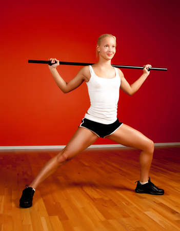 Beautiful blond athlete doing exercise in fitness roomの写真素材
