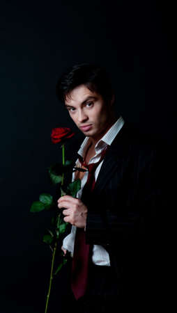 Portrait of handsome man wearing suit and  holding roseの写真素材