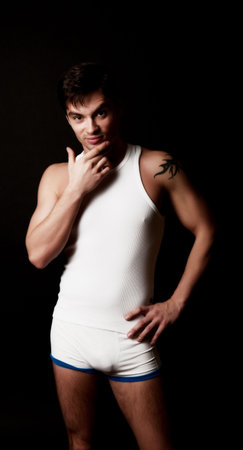 Young man in front of black background 
