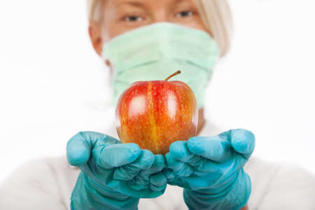Picture of fresh apple in nurses handsの写真素材