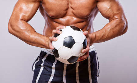 Close image of muscle man with ballの写真素材