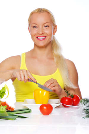 Portrait of woman posing in the kitchen with knifeの写真素材