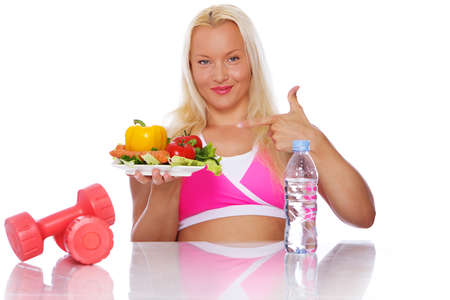 Portrait of sexy woman posing in studio with vegetablesの写真素材