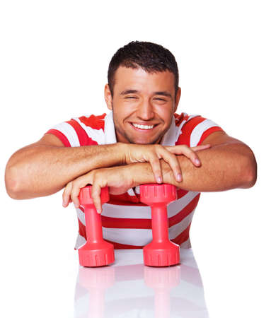 Portrait of sport trainer posing in gym with dumbbellsの写真素材