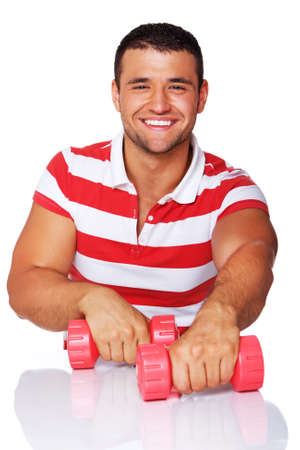 Portrait of smiling woman posing in studio with dumbbellsの写真素材