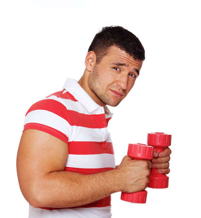 Portrait of sport trainer posing in gym with dumbbellsの写真素材