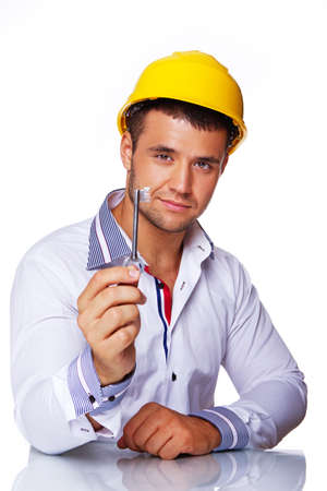 Portrait of smiling engineer posing in studio with key from houseの写真素材