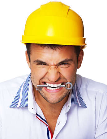Portrait of crazy engineer eating key from houseの写真素材
