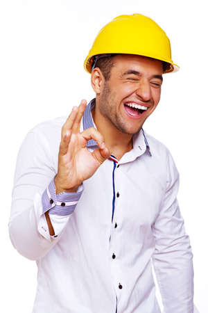 Portrait of smiling engineer posing in studio in helmetの写真素材
