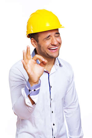 Portrait of smiling engineer posing in studio in helmetの写真素材