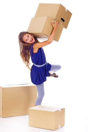 Portrait of little kid posing in studio with a lot of cardboardsの写真素材