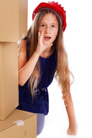 Portrait of little kid posing in studio with a lot of cardboardsの写真素材