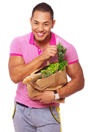 Portrait of handsome man posing in studio with foodの写真素材
