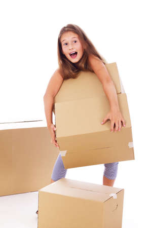 Portrait of little kid posing in studio with a lot of cardboardsの写真素材