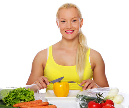 Portrait of sexy woman eating vegetablesの写真素材