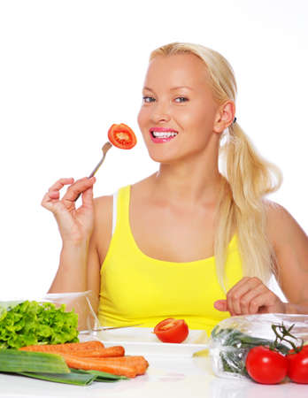 Portrait of vegetarian eating tomato on the kitchenの写真素材