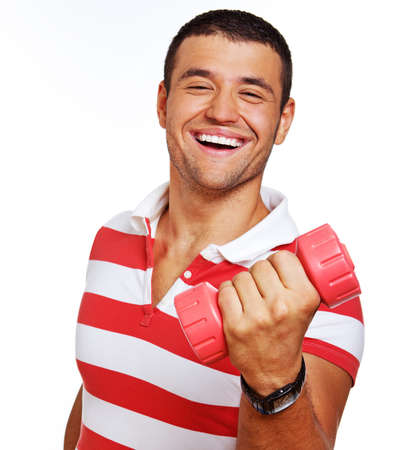 Portrait of young trainer posing in studio with dumbbellsの写真素材