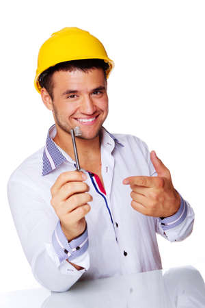 Portrait of smiling engineer posing in studio with key from houseの写真素材