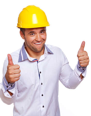 Portrait of handsome engineer posing in studio in helmetの写真素材