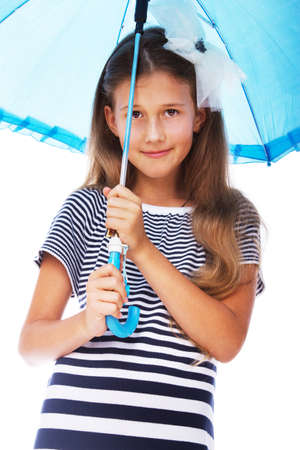 Portrait of little kid posing in studio with umbrella in rainy dayの写真素材