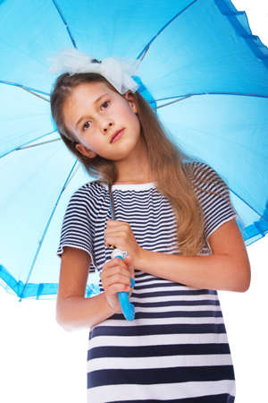 Portrait of little kid posing in studio with umbrella in rainy dayの写真素材
