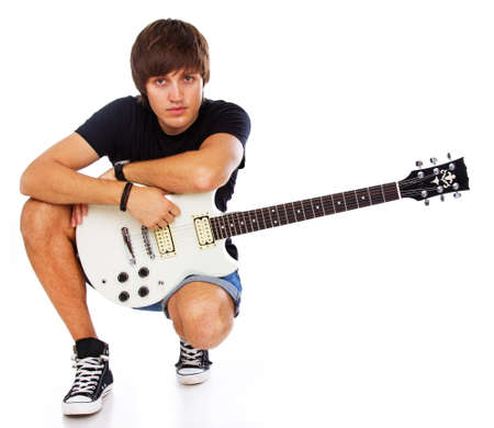 Portrait of rock artist posint in studio with guitarの写真素材