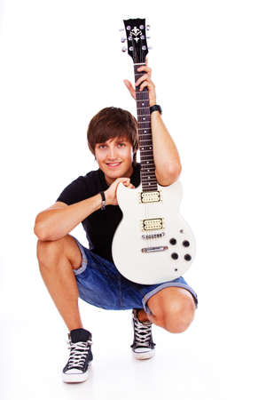 Portrait of rock artist posint in studio with guitarの写真素材
