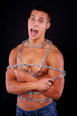 A sexy young male is held captiveの写真素材
