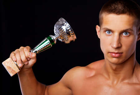 A photo of a young athlete holding a prizeの写真素材