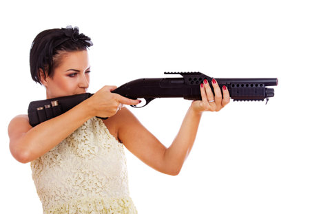 Portrait of sexy woman posing in studio with gun