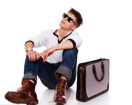 Portrait of sereous man posing in studio with bagの写真素材