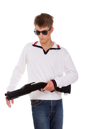 Portrait of sereous man posing in studio with gunの写真素材