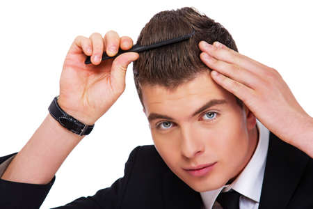 A young man is smartening himself upの写真素材