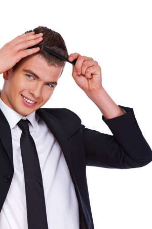 A man in a suit with a combの写真素材