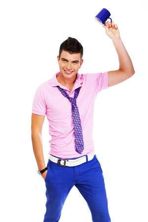 Picture of a stylish young man waving a cup over his headの写真素材