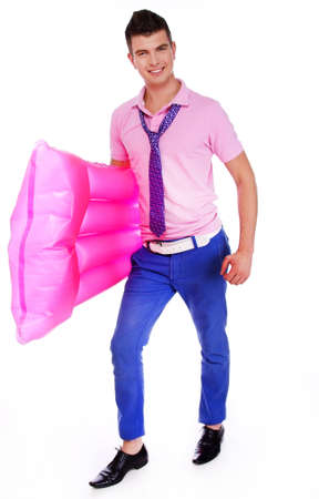 A young man carrying a swimmig pool inflatableの写真素材