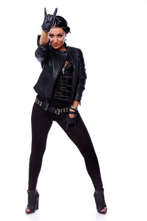 Portrait of sexy brunet posing in studio in leatherの写真素材